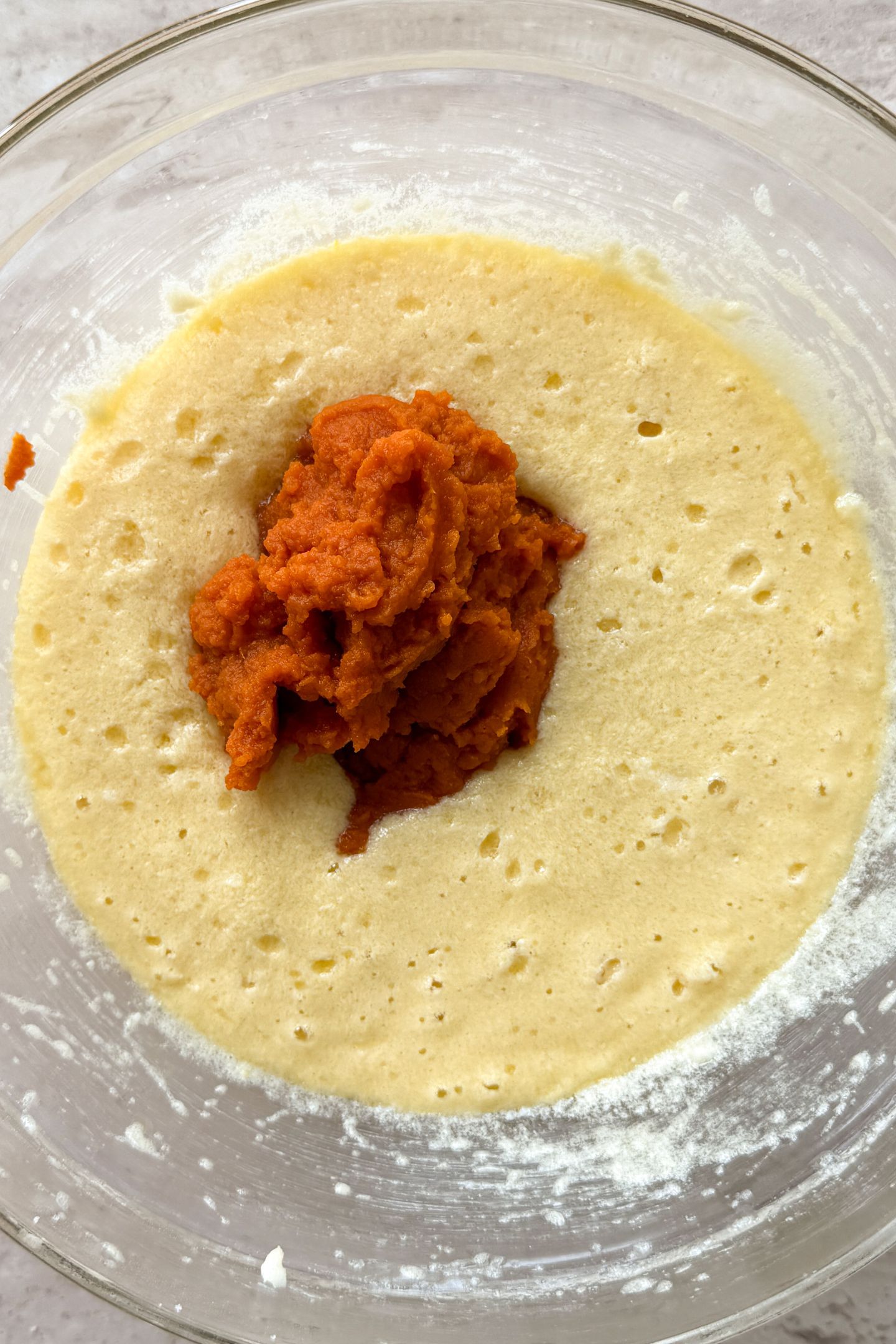 Adding the pumpkin puree to the wet ingredients.