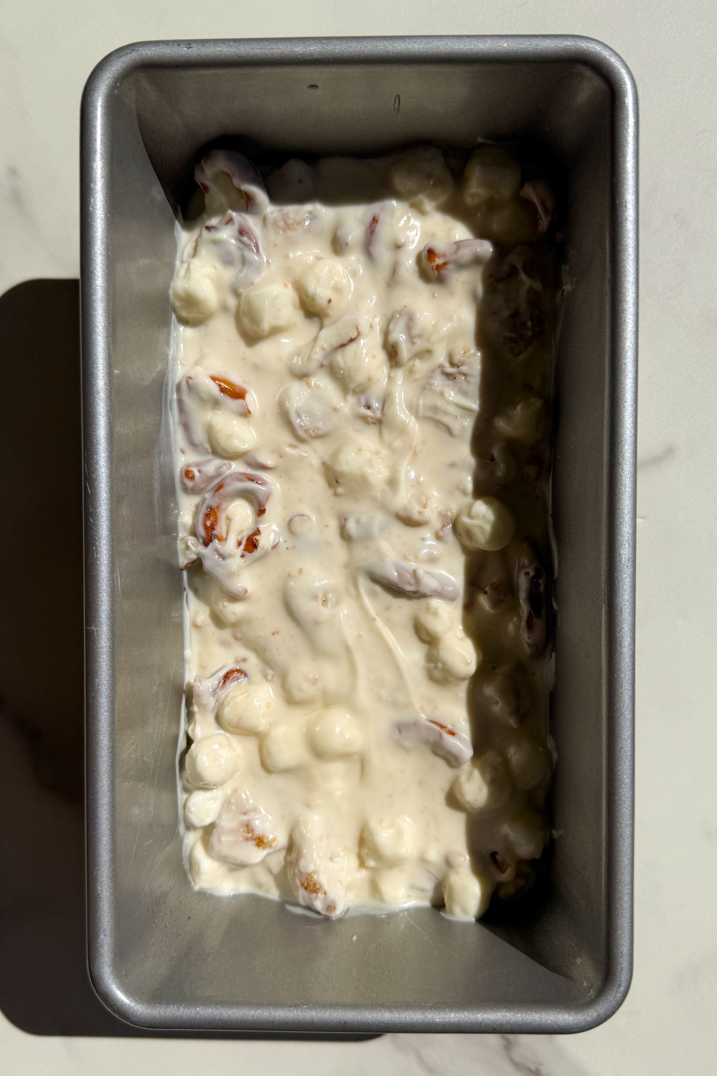 White Chocolate Rocky Road mixture transferred to a loaf pan.