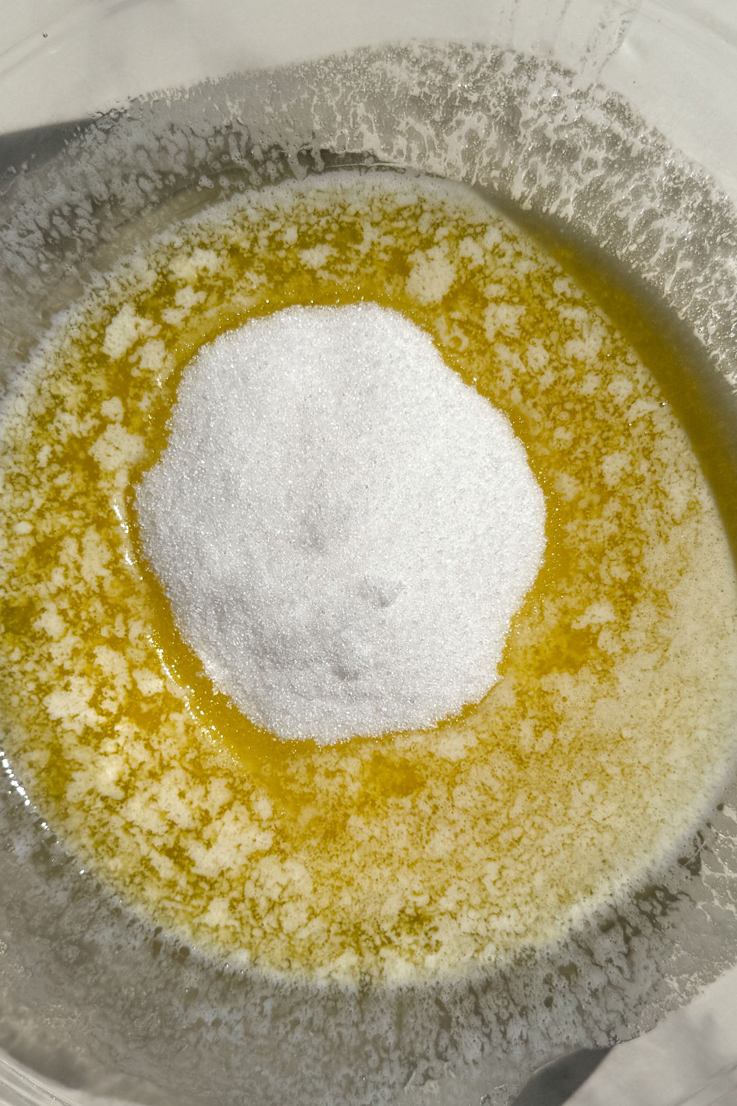 Melted butter in a bowl with granulated sugar.