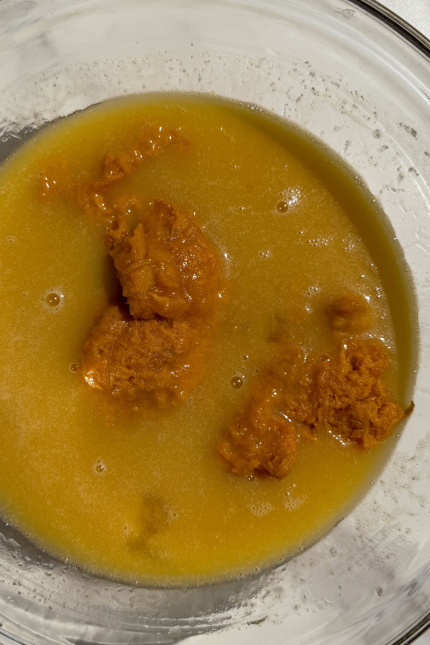 Adding sweet potato to the sugar and butter in a bowl.