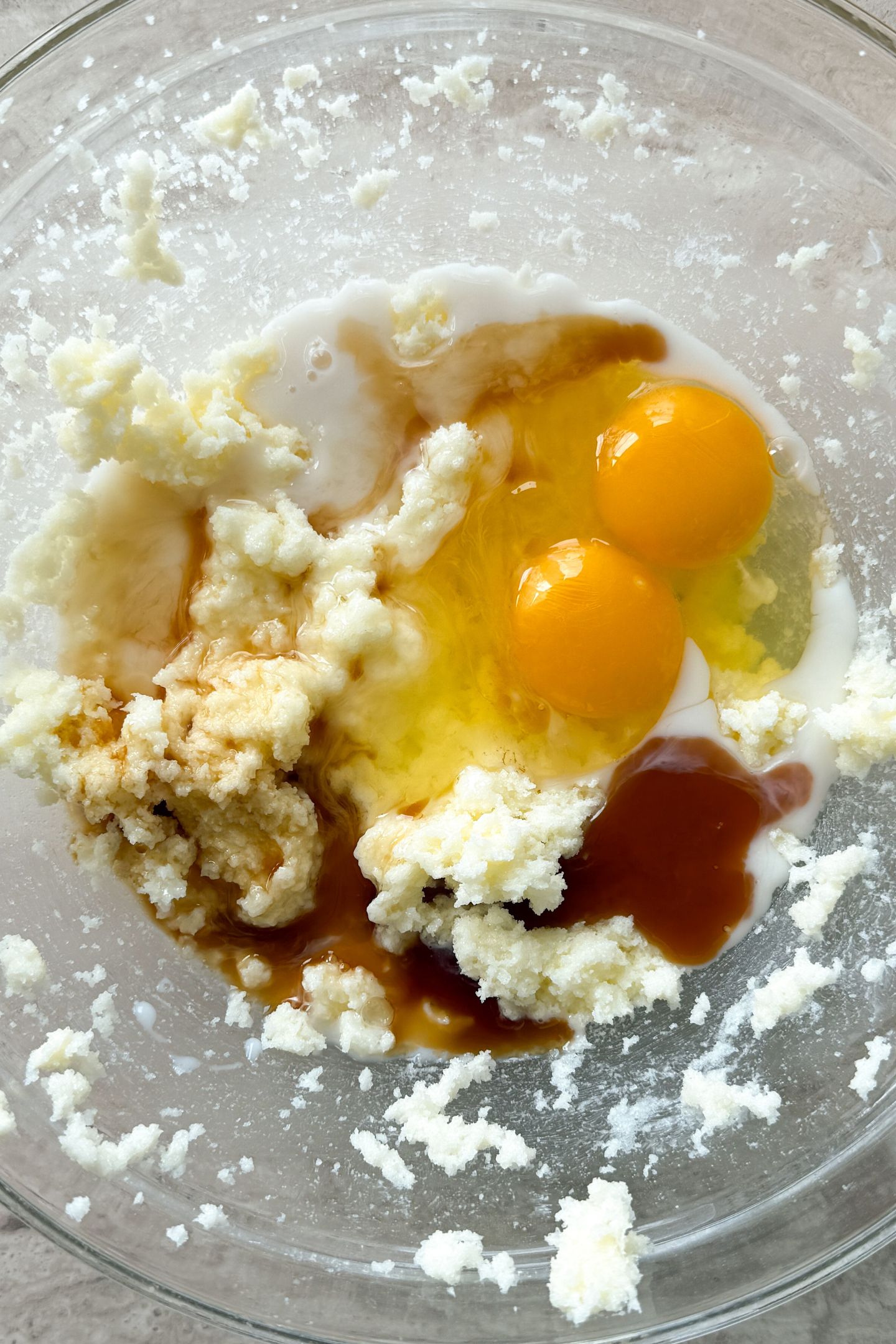 Eggs, vanilla and milk being added to the bowl with wet ingredients.