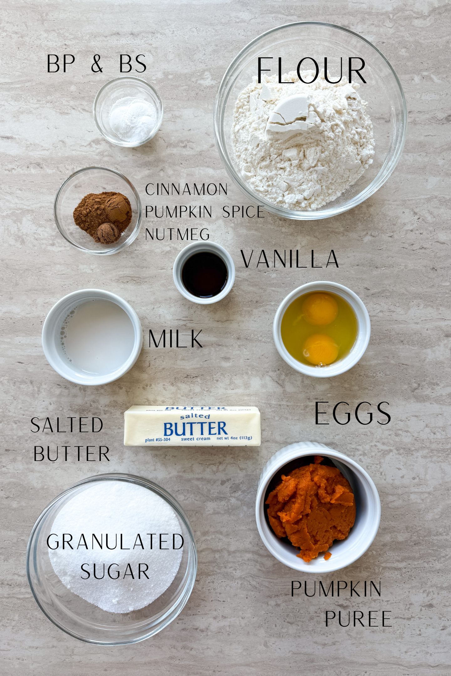 Ingredients measured out in bowls to make the pumpkin bread.