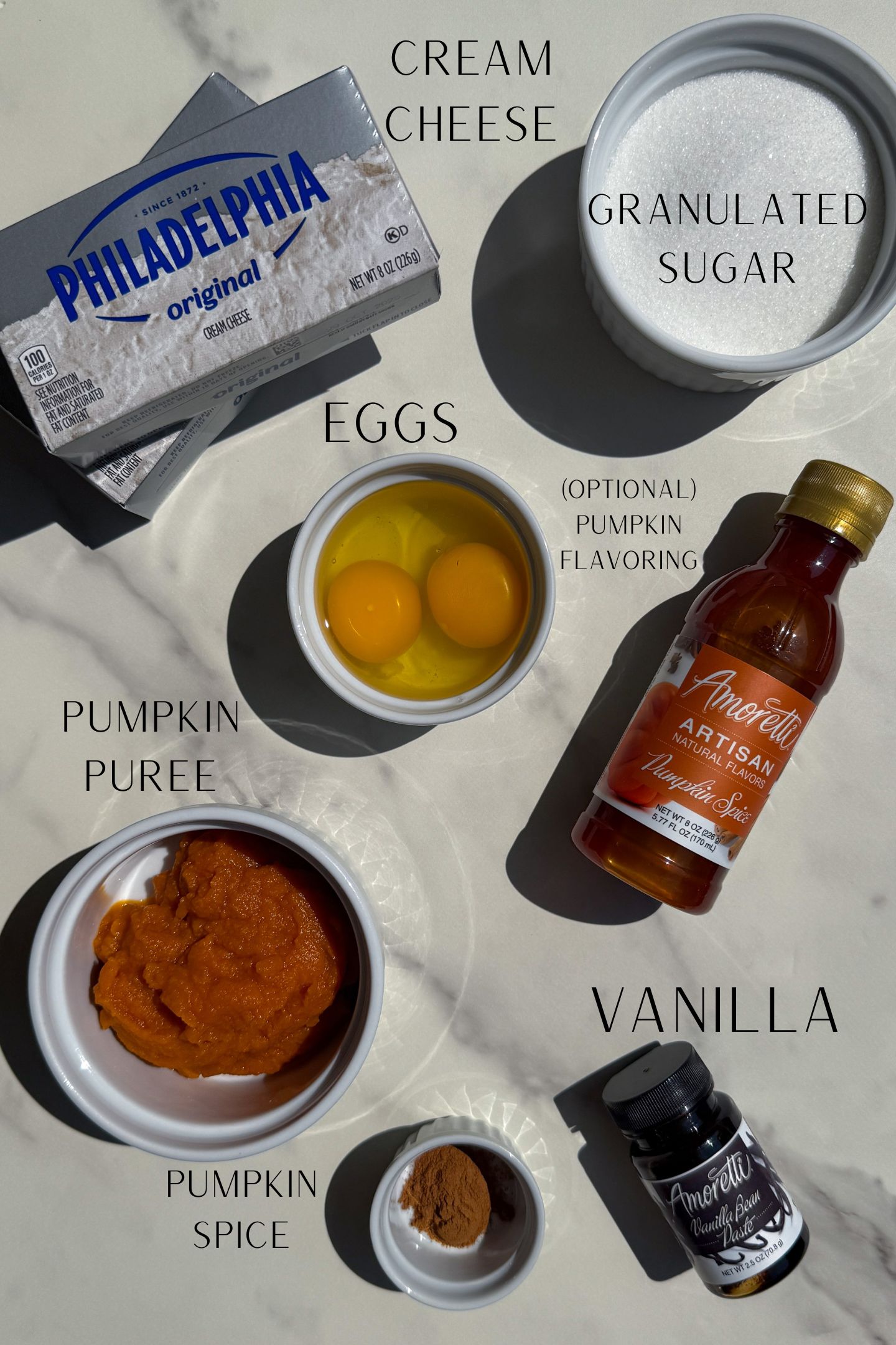Ingredients measured out in bowls to make the pumpkin cheesecake.