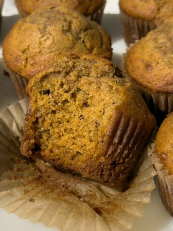 Pumpkin Banana Bread Muffin with a bite taken out of it.