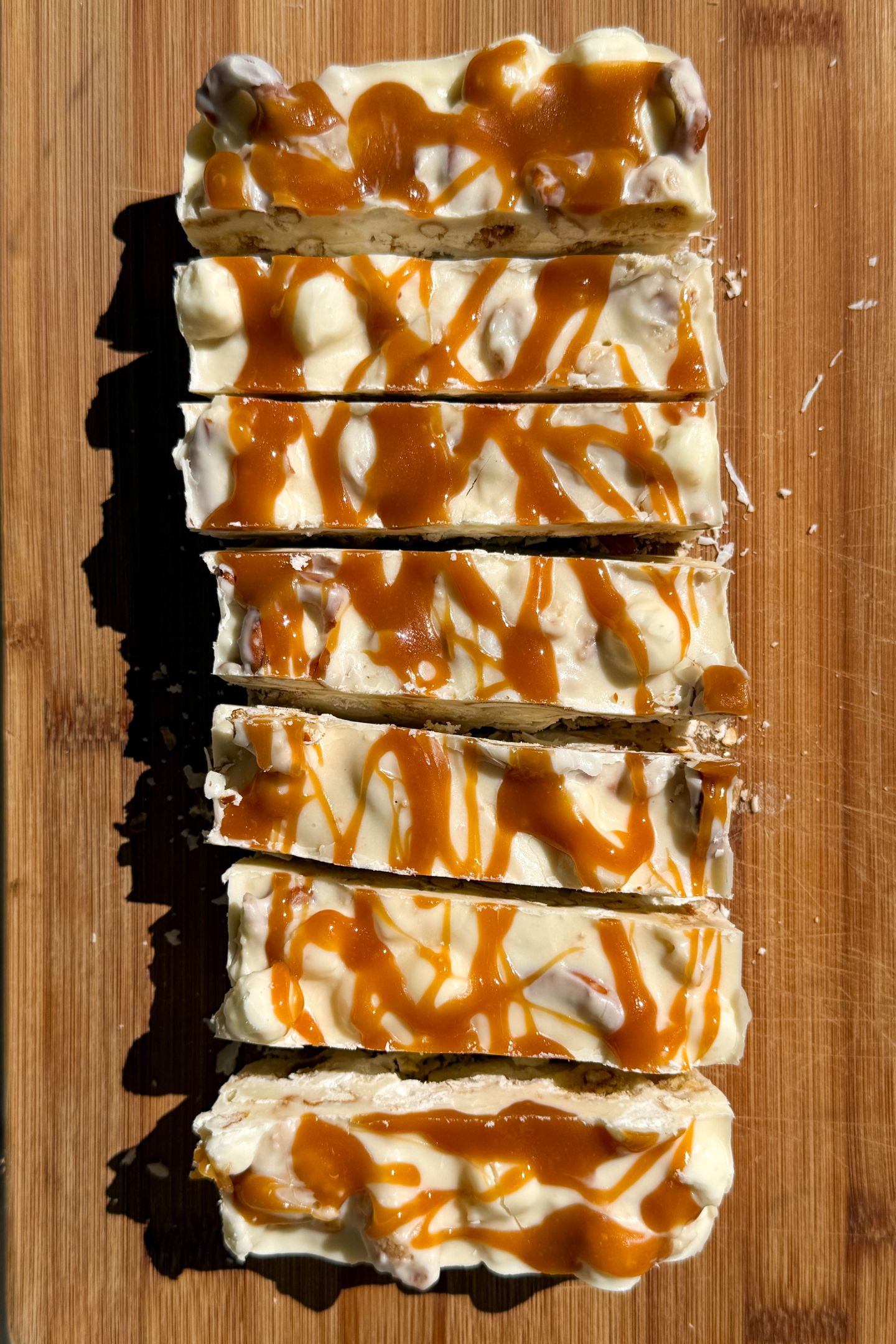 Slicing the rocky road on a cutting board.