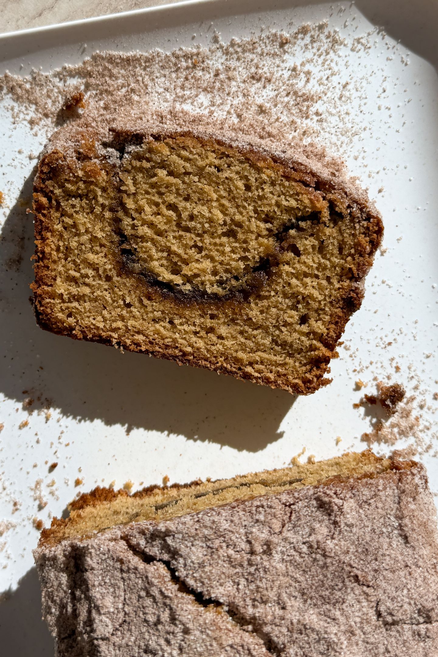 Slicing the apple cider bread on a platter.