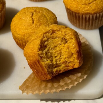 Corn and sweet potato muffin with a bite taken out of it.