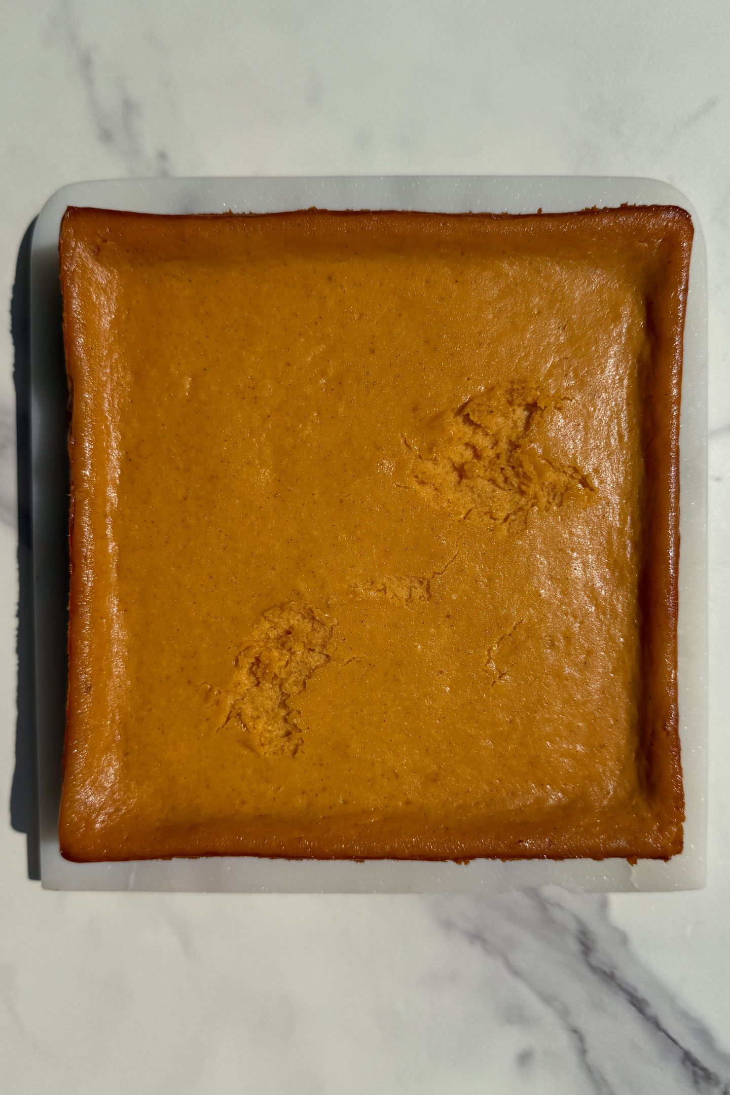 Baked pumpkin cheesecake cooling.