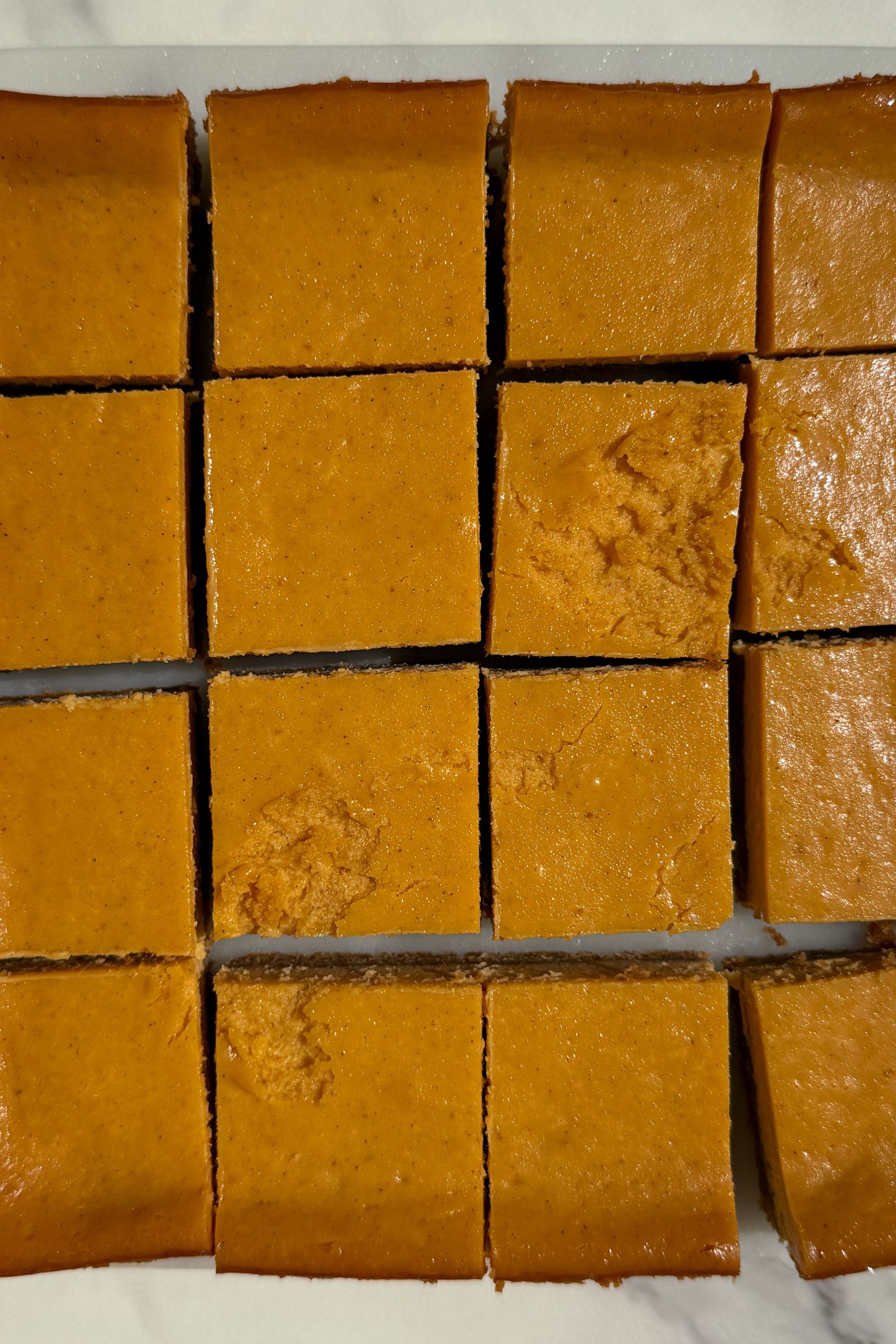 Sliced pumpkin cheesecake on a platter.