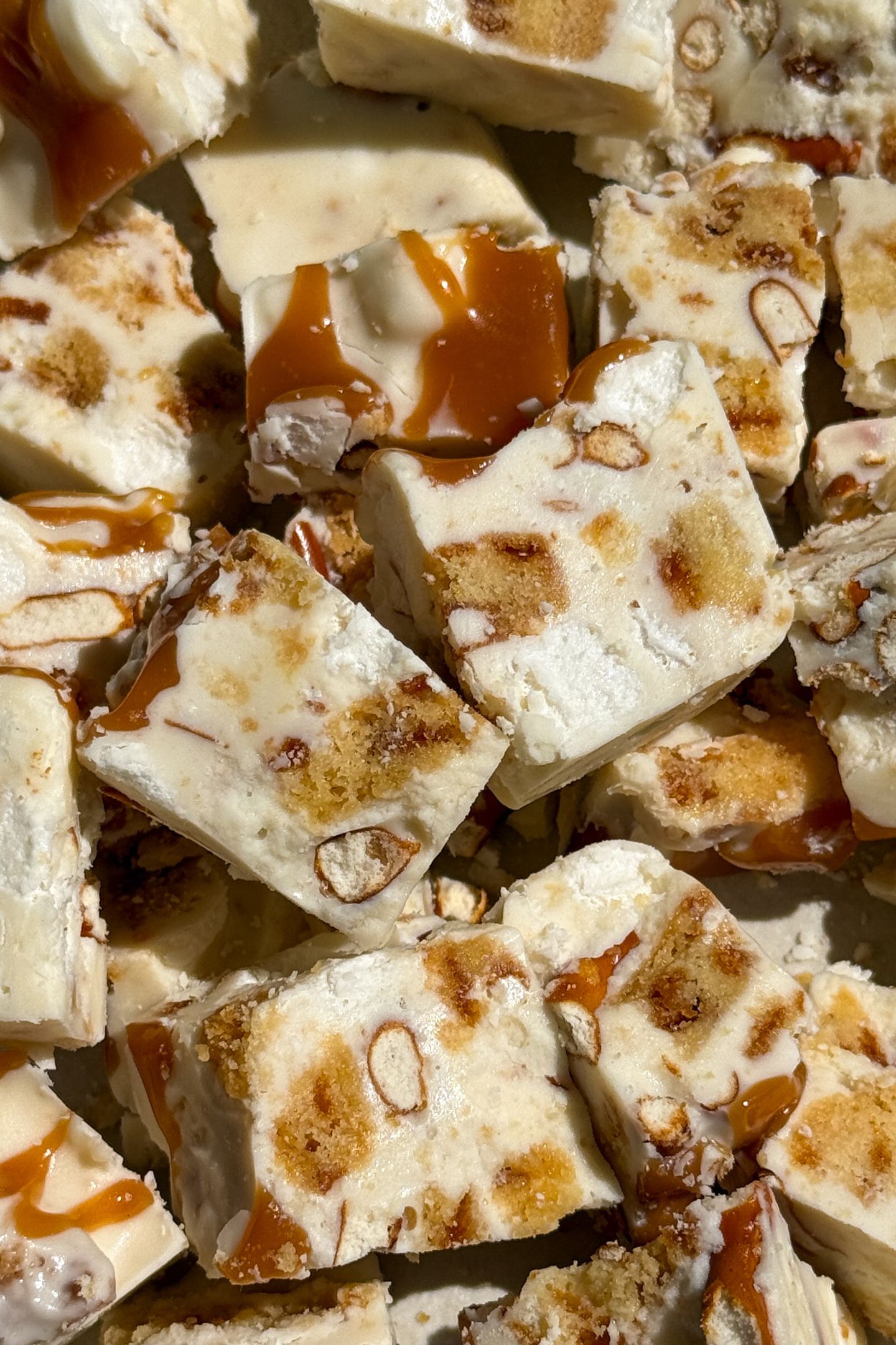 Pieces of white chocolate rocky road with caramel, cookies and pretzels.
