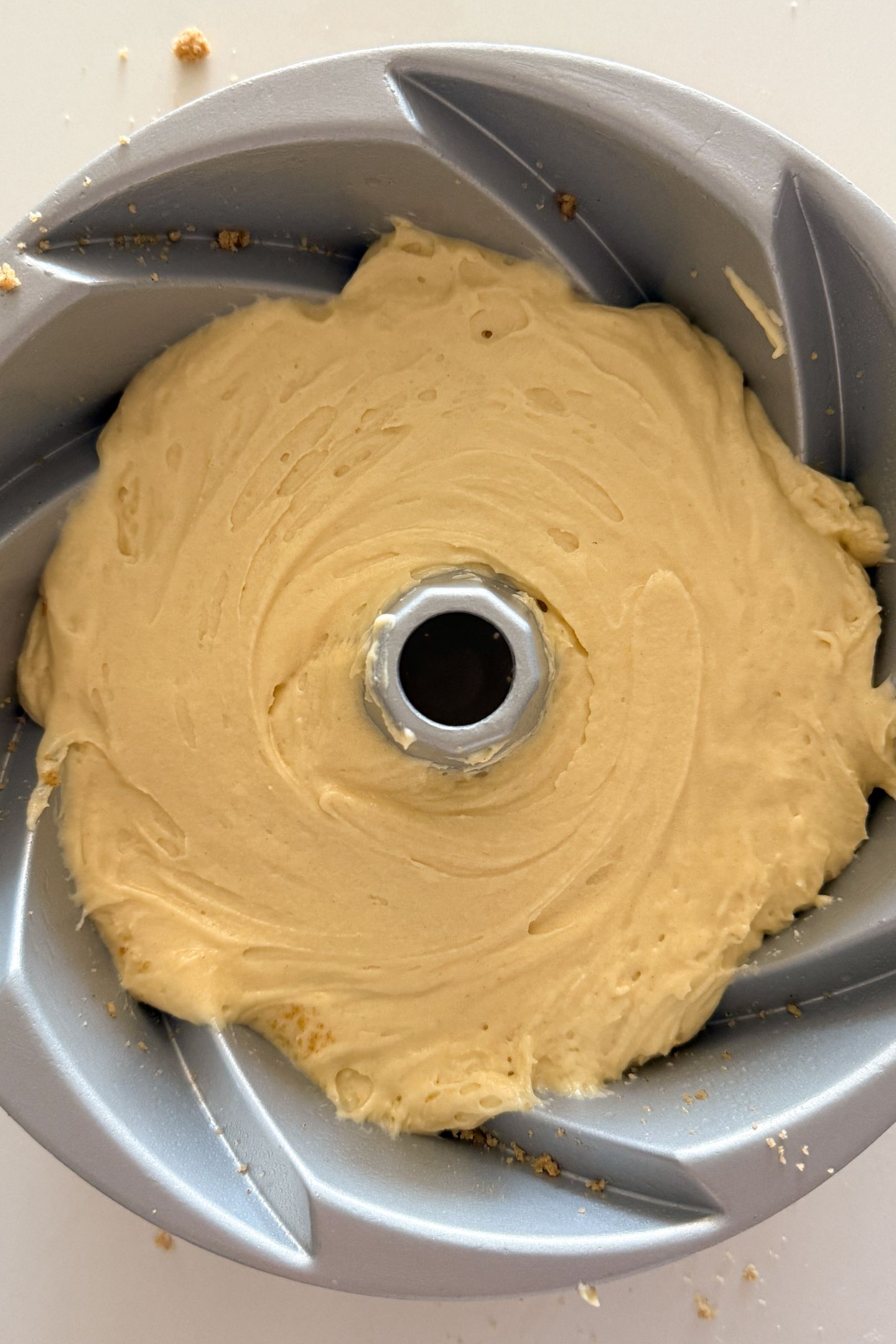 Spreading batter on top of the crumble.