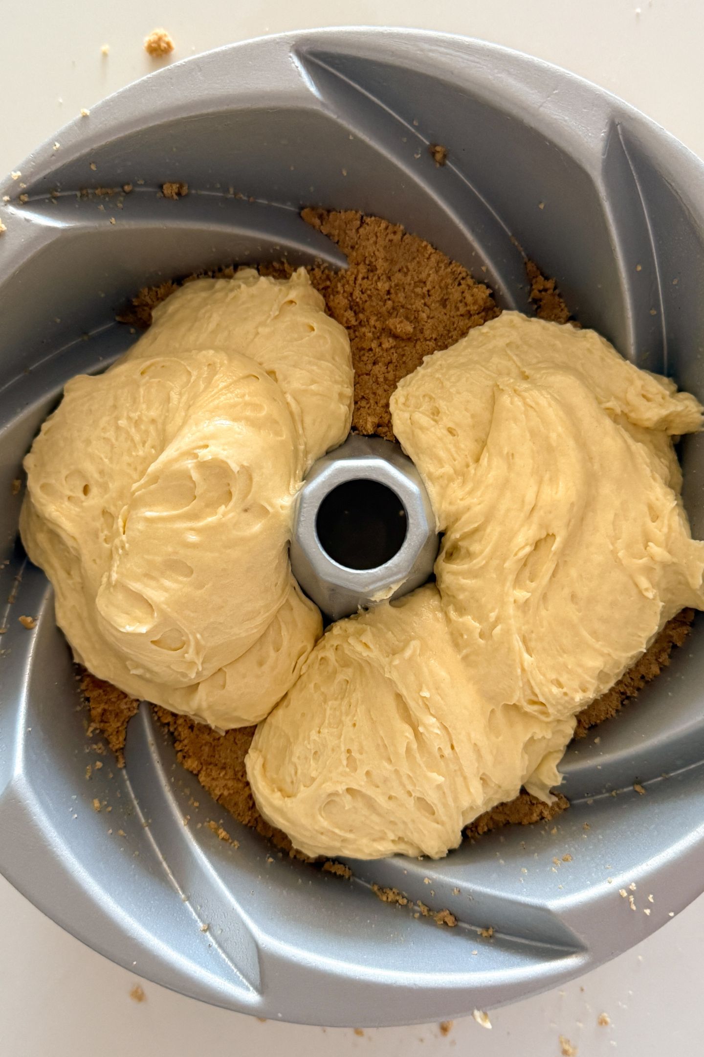 Adding batter on top of the crumble.