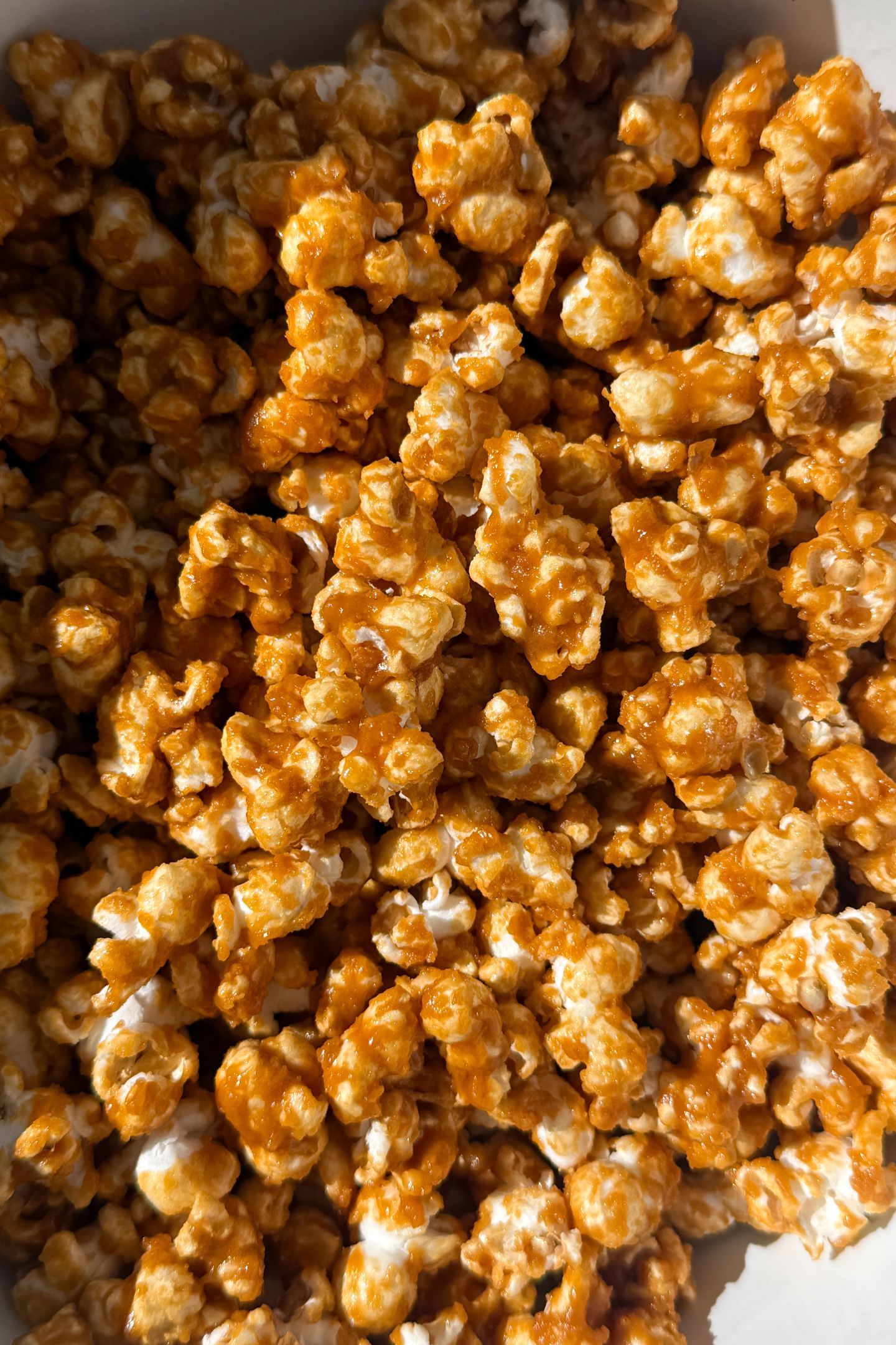 Mixing the popcorn and caramel sauce together.