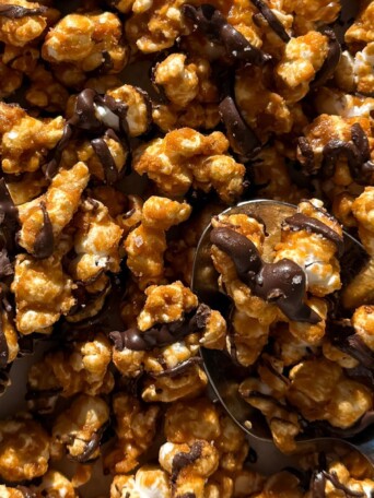 Chocolate Caramel Popcorn on a baking sheet lined with parchment paper.