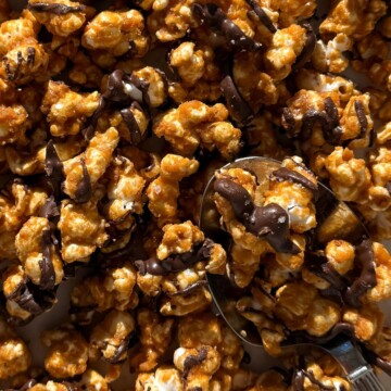 Chocolate Caramel Popcorn on a baking sheet lined with parchment paper.