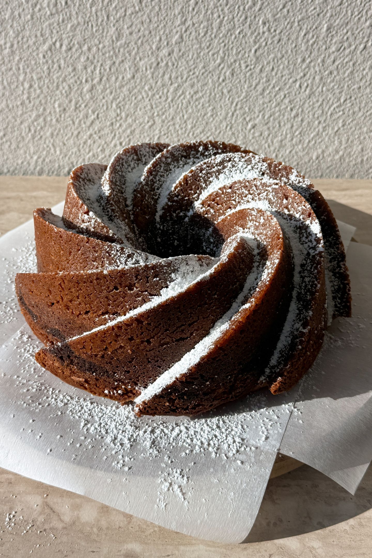 The bundt cake topped with powdered sugar.