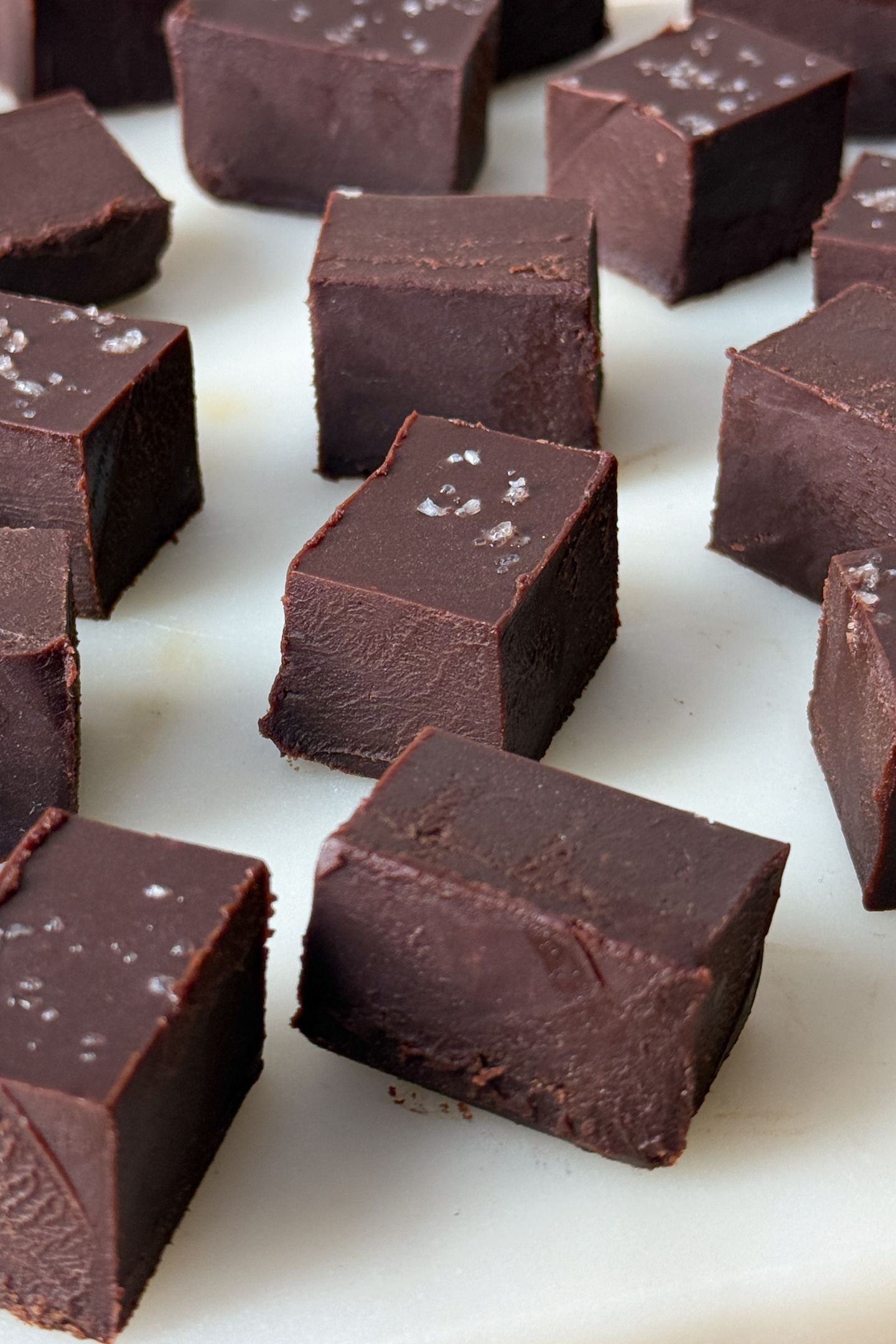 Pieces of dark chocolate fudge on a serving platter.