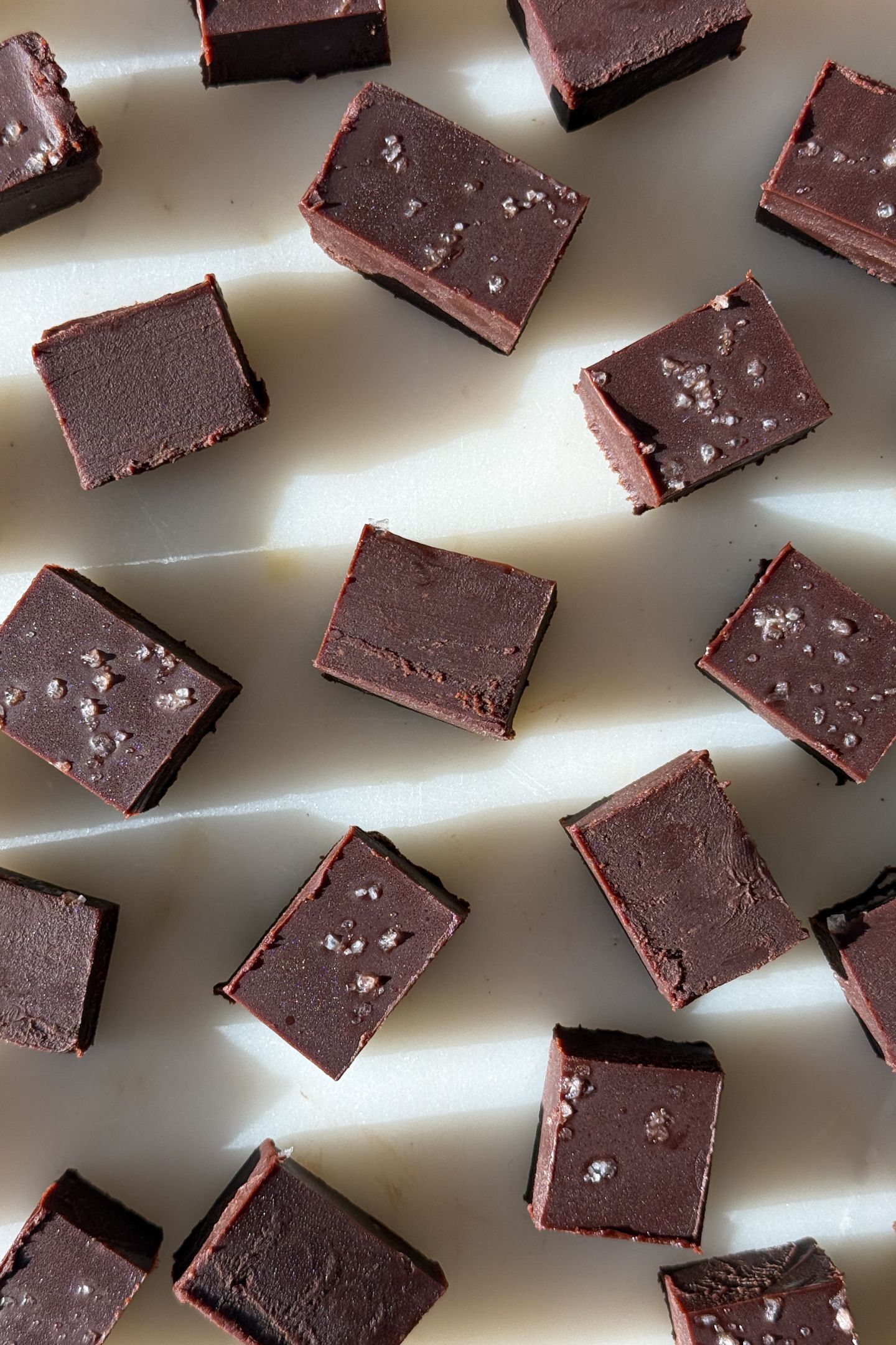 Pieces of dark chocolate fudge on a serving platter.