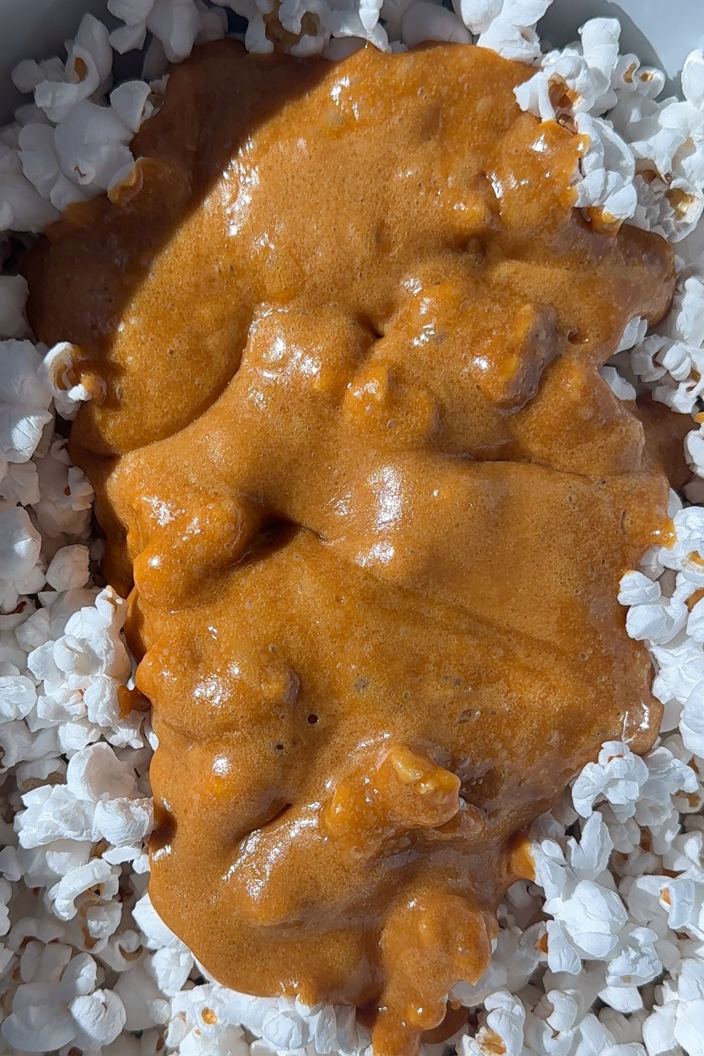 Caramel sauce poured over the popcorn.