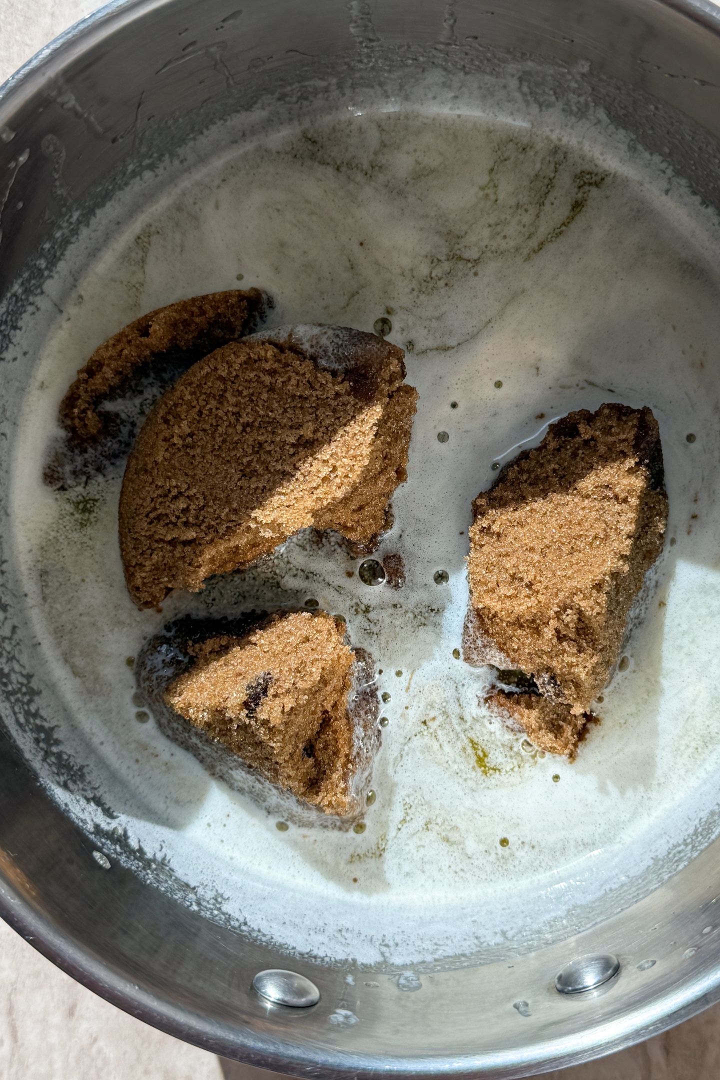 Melted butter in a saucepan with dark brown sugar.