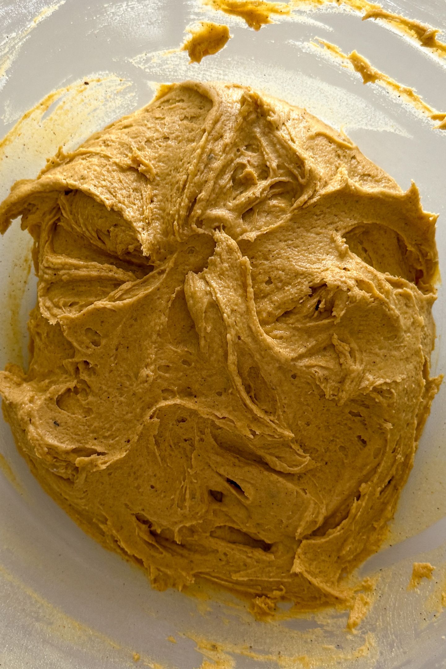 Pumpkin cookie batter in bowl.