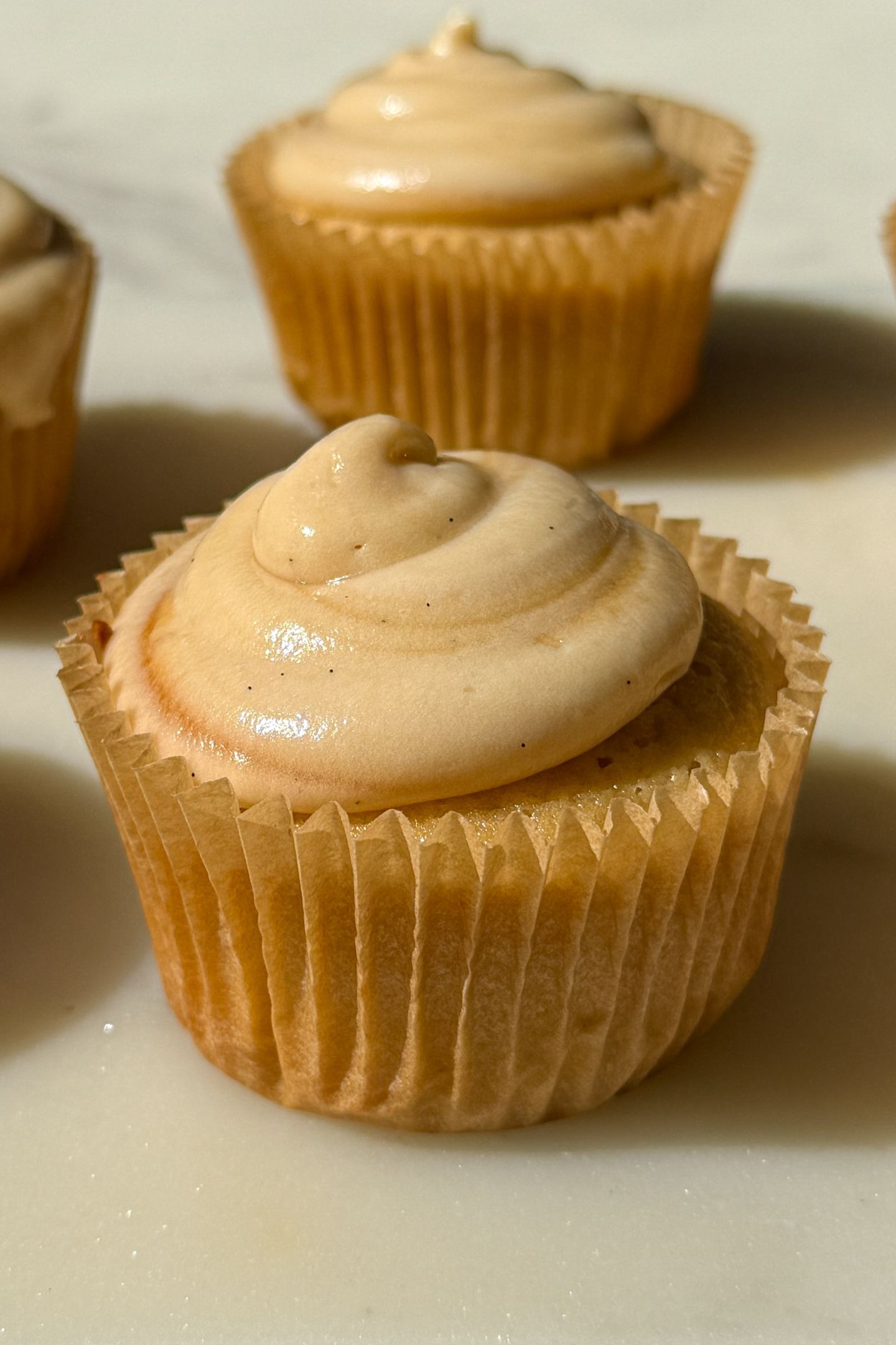 Cupcake topped with salted caramel frosting.
