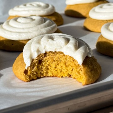 Frosted Pumpkin Cookie with a bite taken out of it.