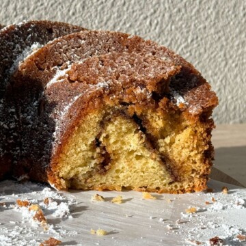 Side view of Coffee Cake Bundt Cake with a cinnamon swirl in the middle.