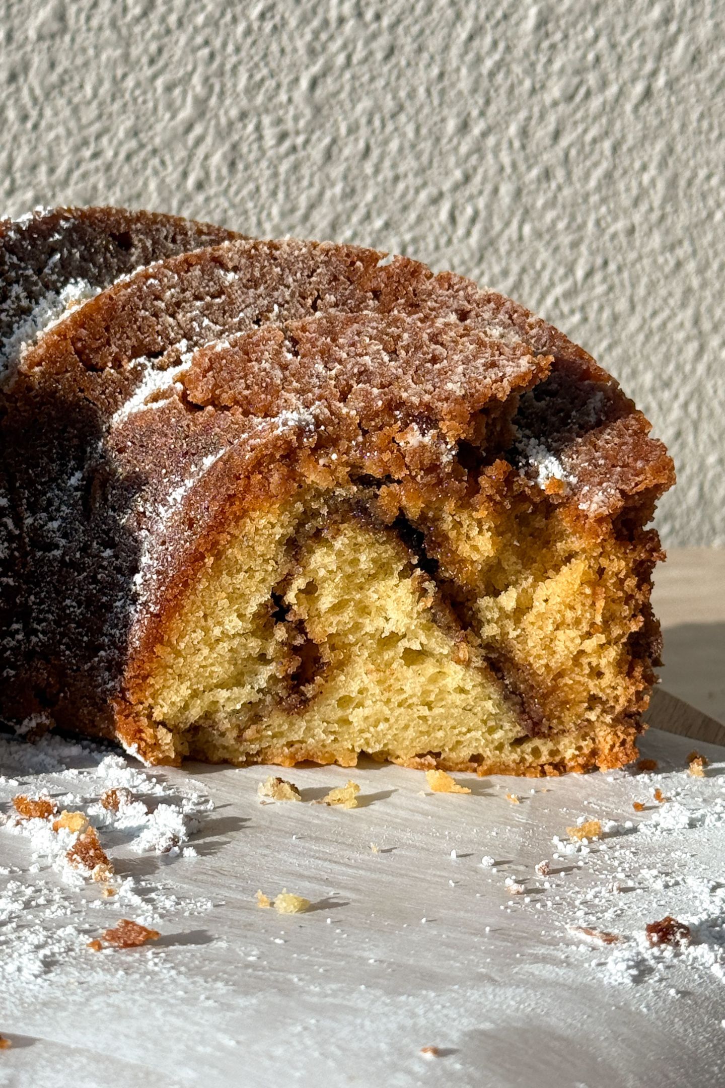 Side view of the coffee cake bundt cake to show the layers and cinnamon swirl.