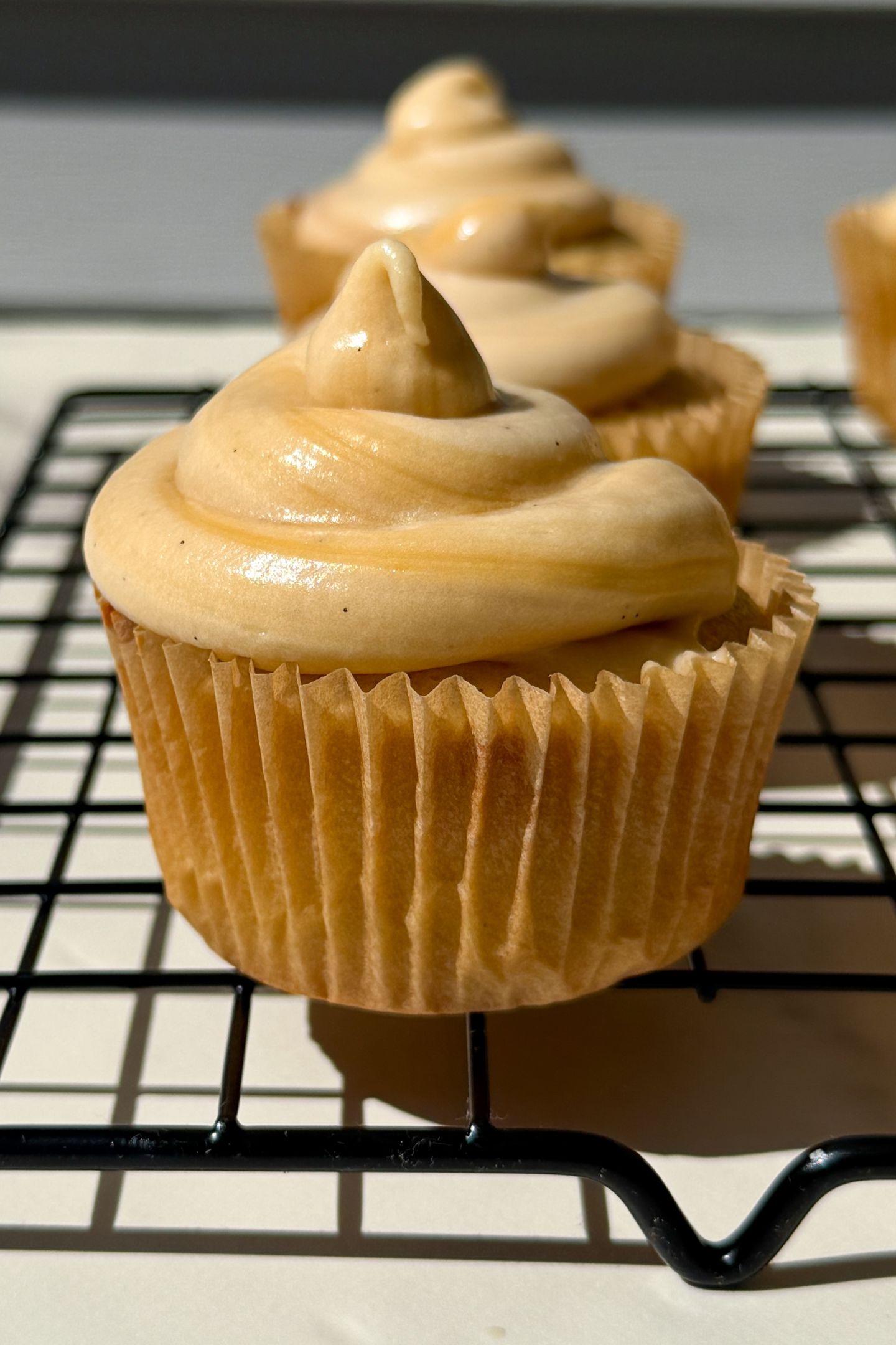 Cupcake topped with salted caramel frosting.