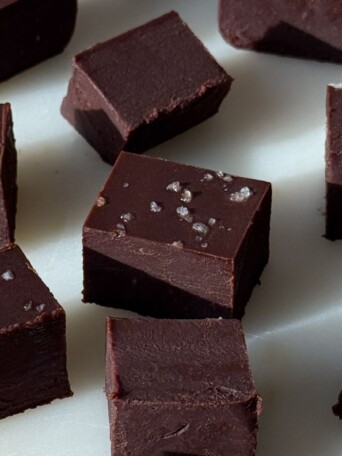 Pieces of dark chocolate fudge on a serving platter.
