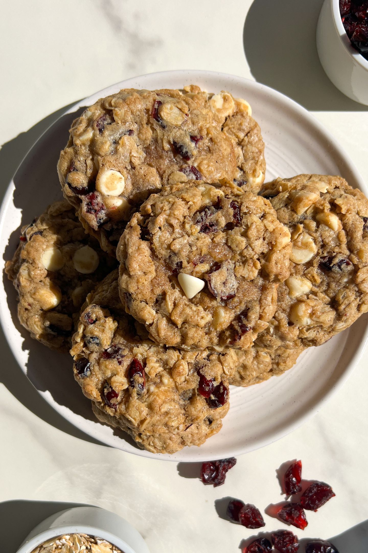 A plate of White Chocolate Dried Cranberry Oatmeal Cookies.