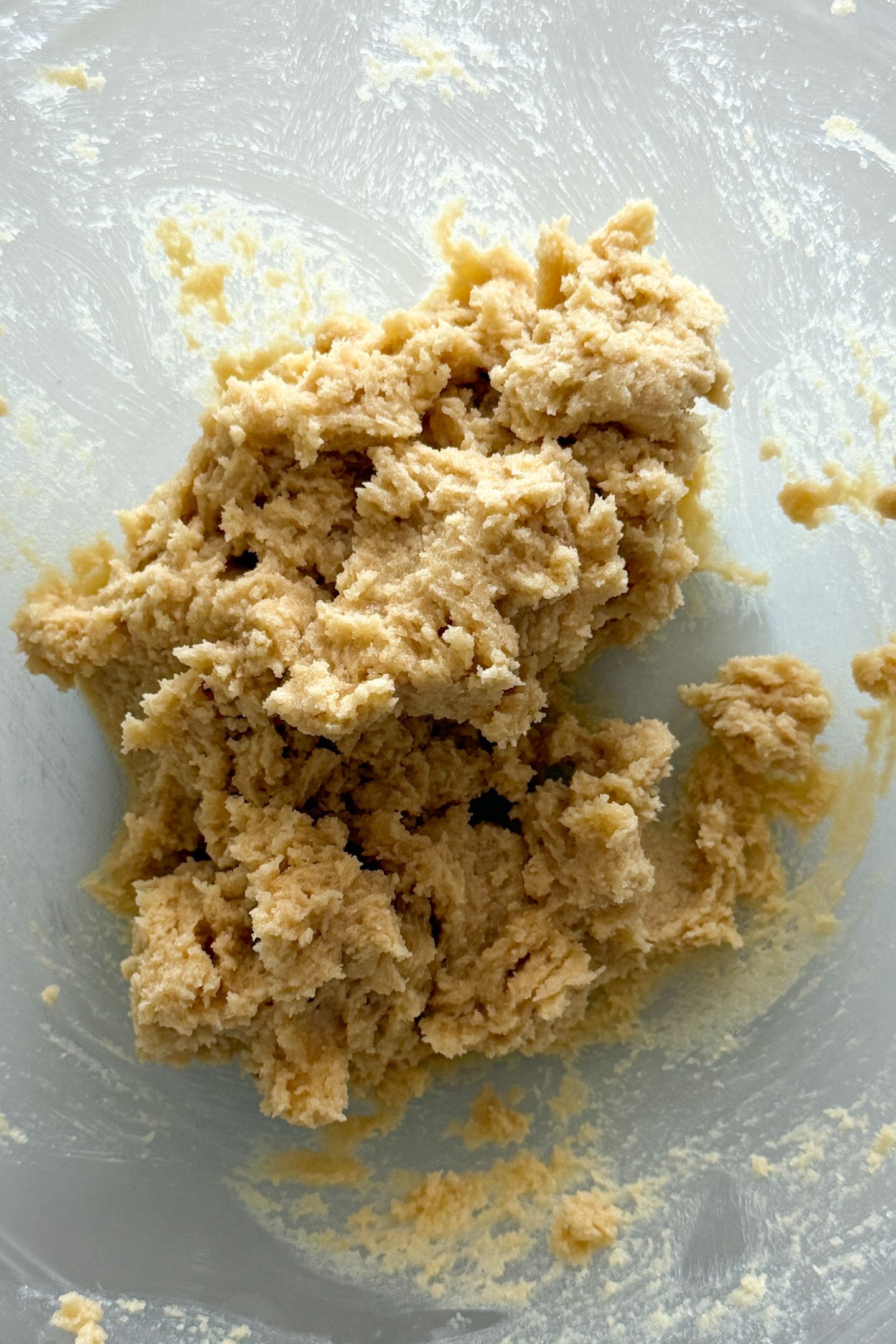 Butter and sugar combined in a mixing bowl.