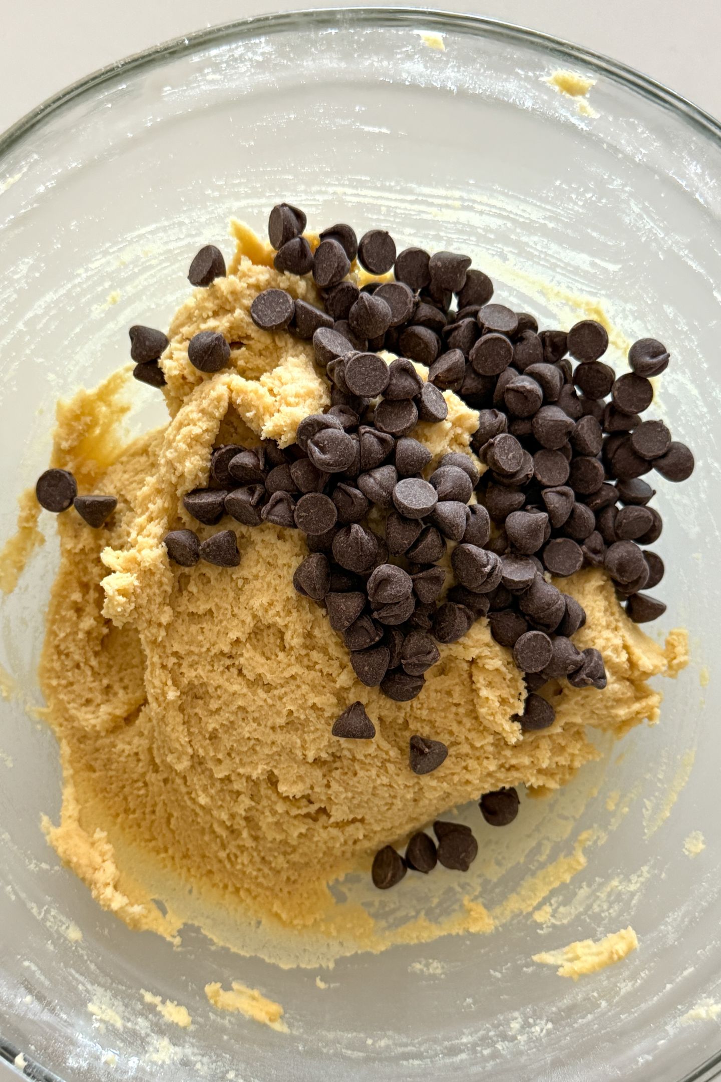 Adding chocolate chips to the cookie dough.