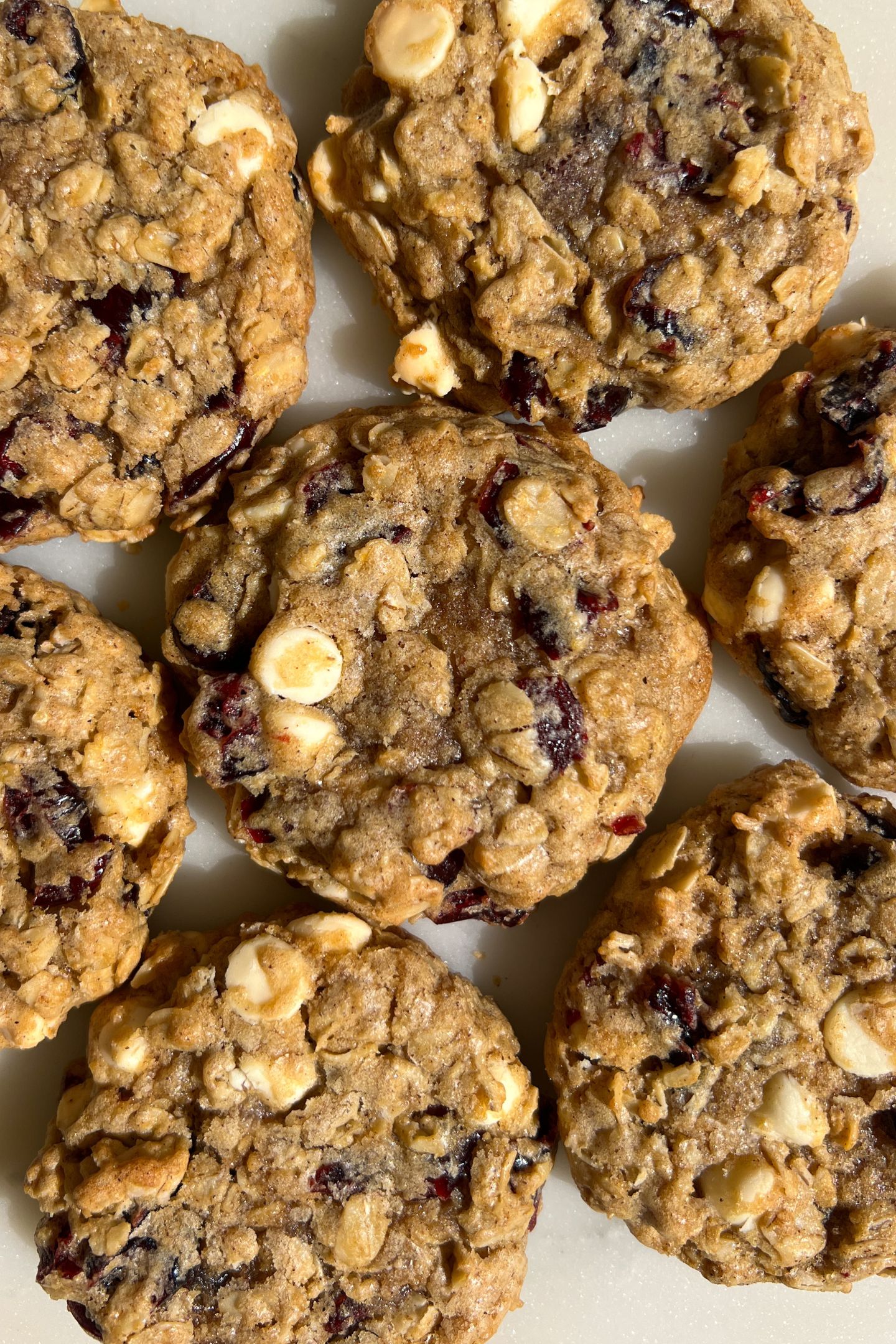 White chocolate and dried cranberry cookies on a platter.