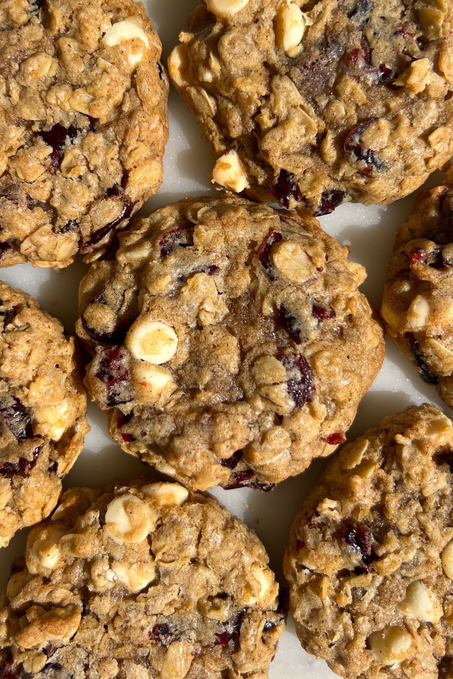 Close up photo to show the white chocolate and dried cranberries in the oatmeal cookies.