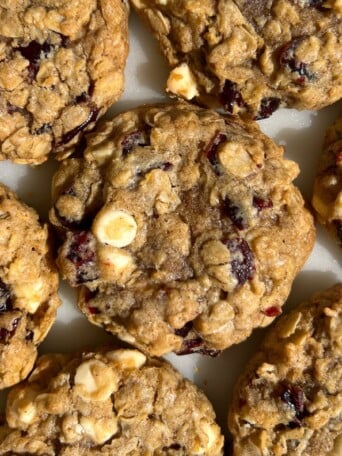 Close up photo to show the white chocolate and dried cranberries in the oatmeal cookies.