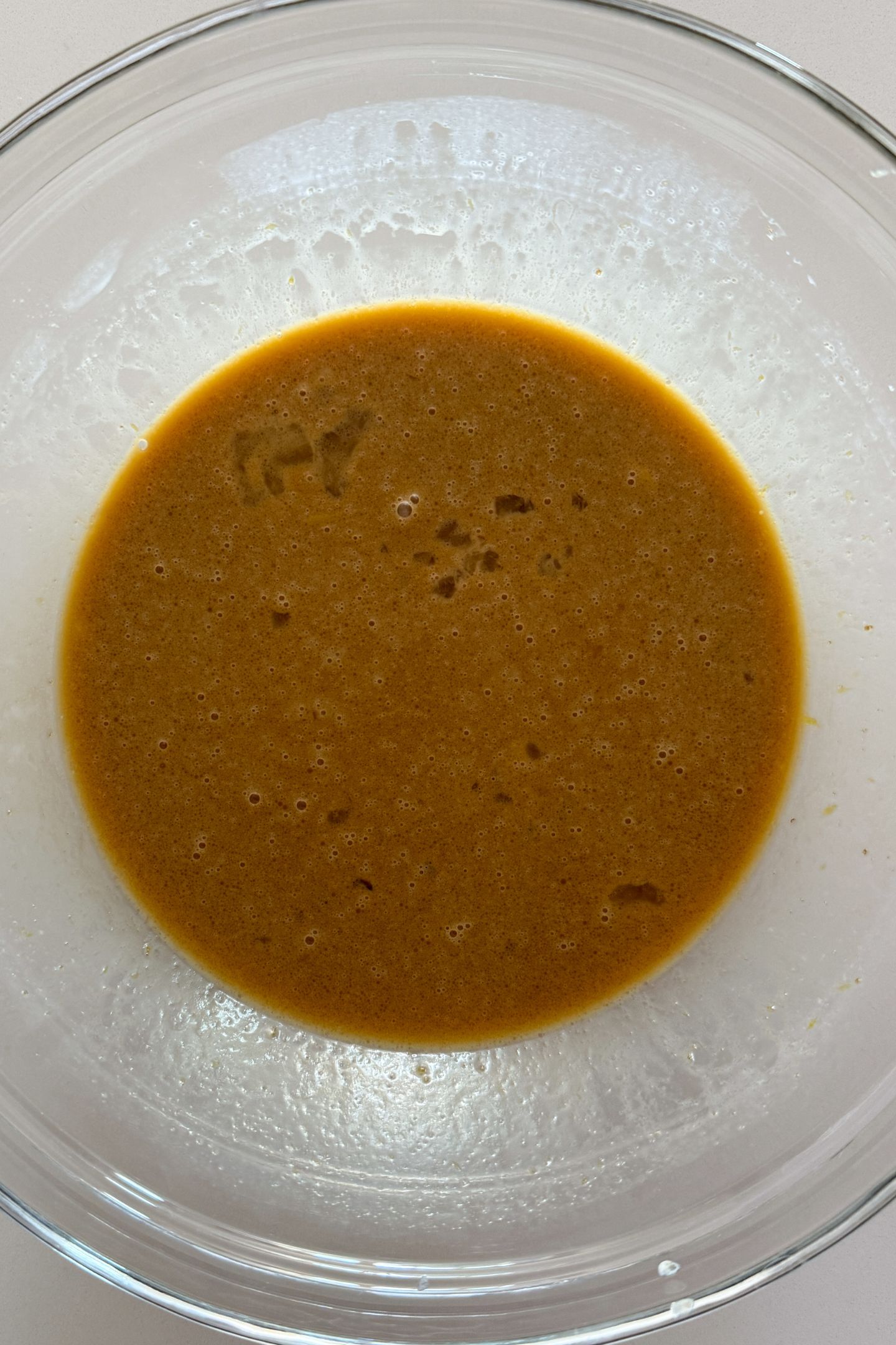 Wet ingredients mixed together in a large mixing bowl.