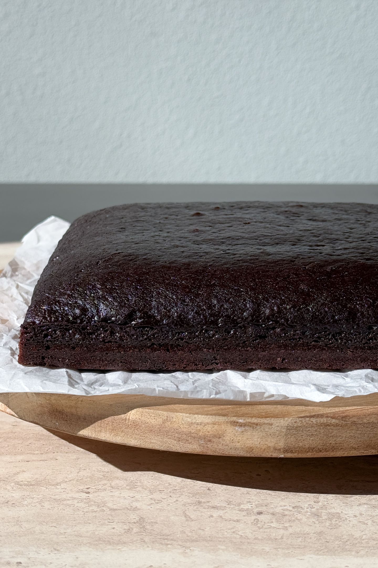 Chocolate cake on a turn table to add the salted caramel and frosting.
