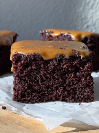 Slice of chocolate cake topped with a salted caramel sauce.