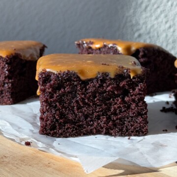 Slice of chocolate cake topped with a salted caramel sauce.