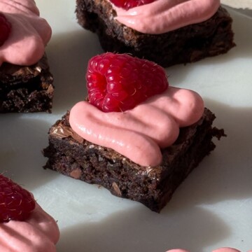 A fudge brownie topped with a swirl of raspberry cream cheese frosting.