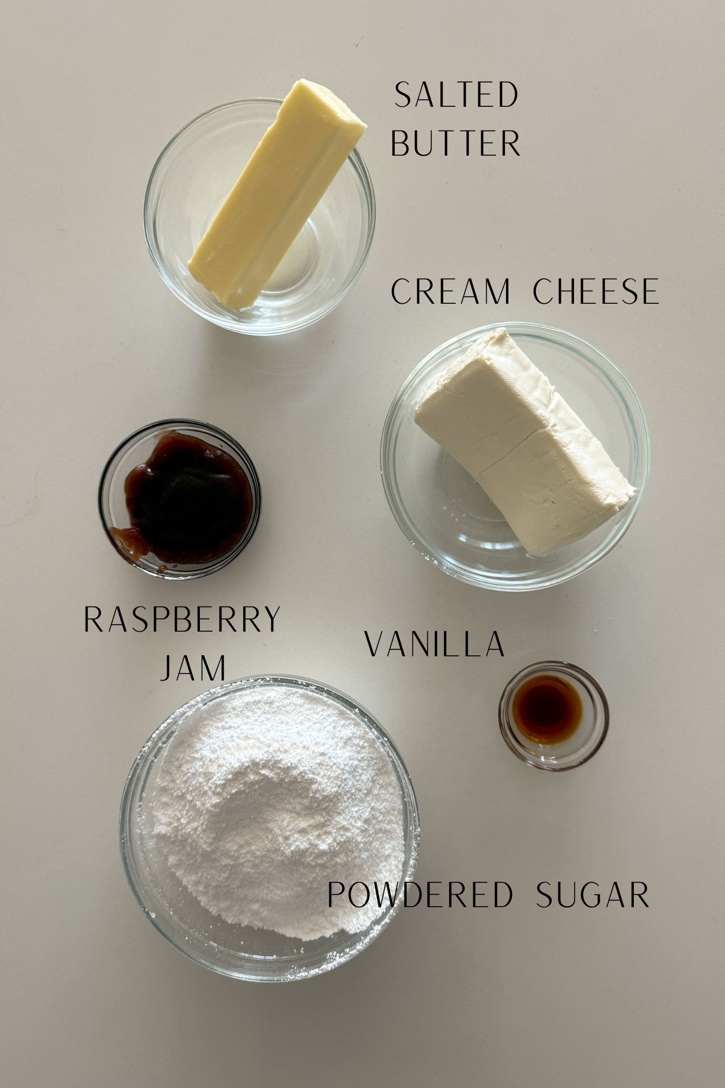 Ingredients measured out in bowls to make raspberry frosting.