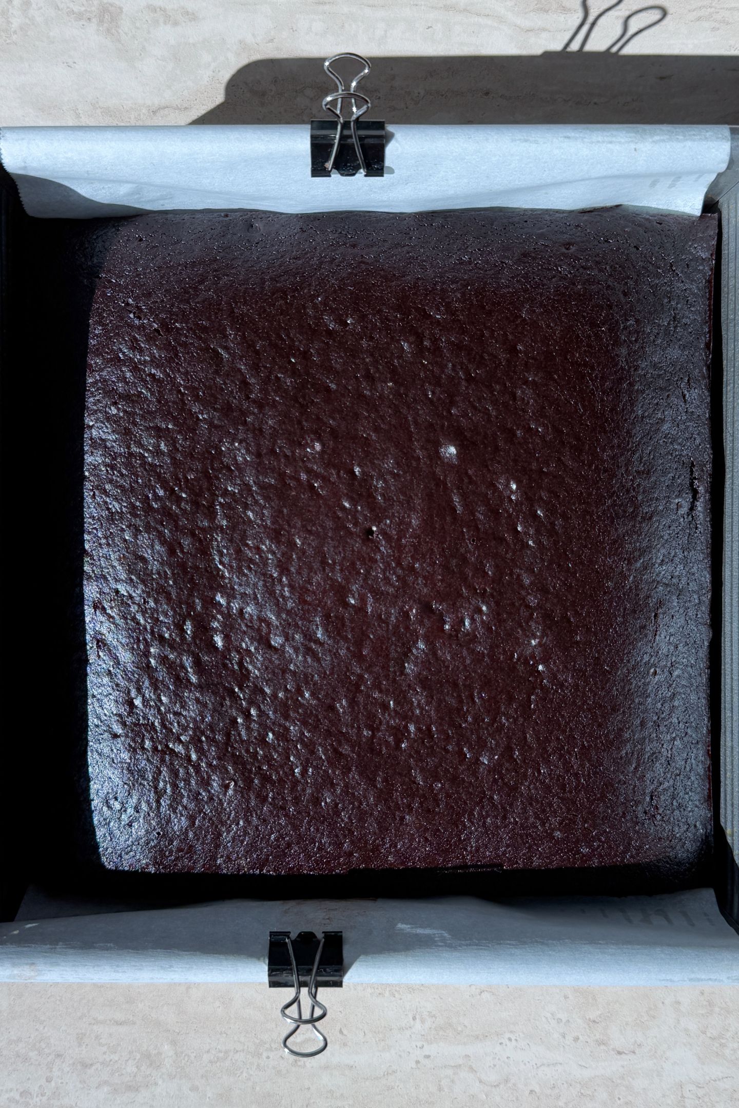 Baked chocolate cake in a 8x8 square baking pan.