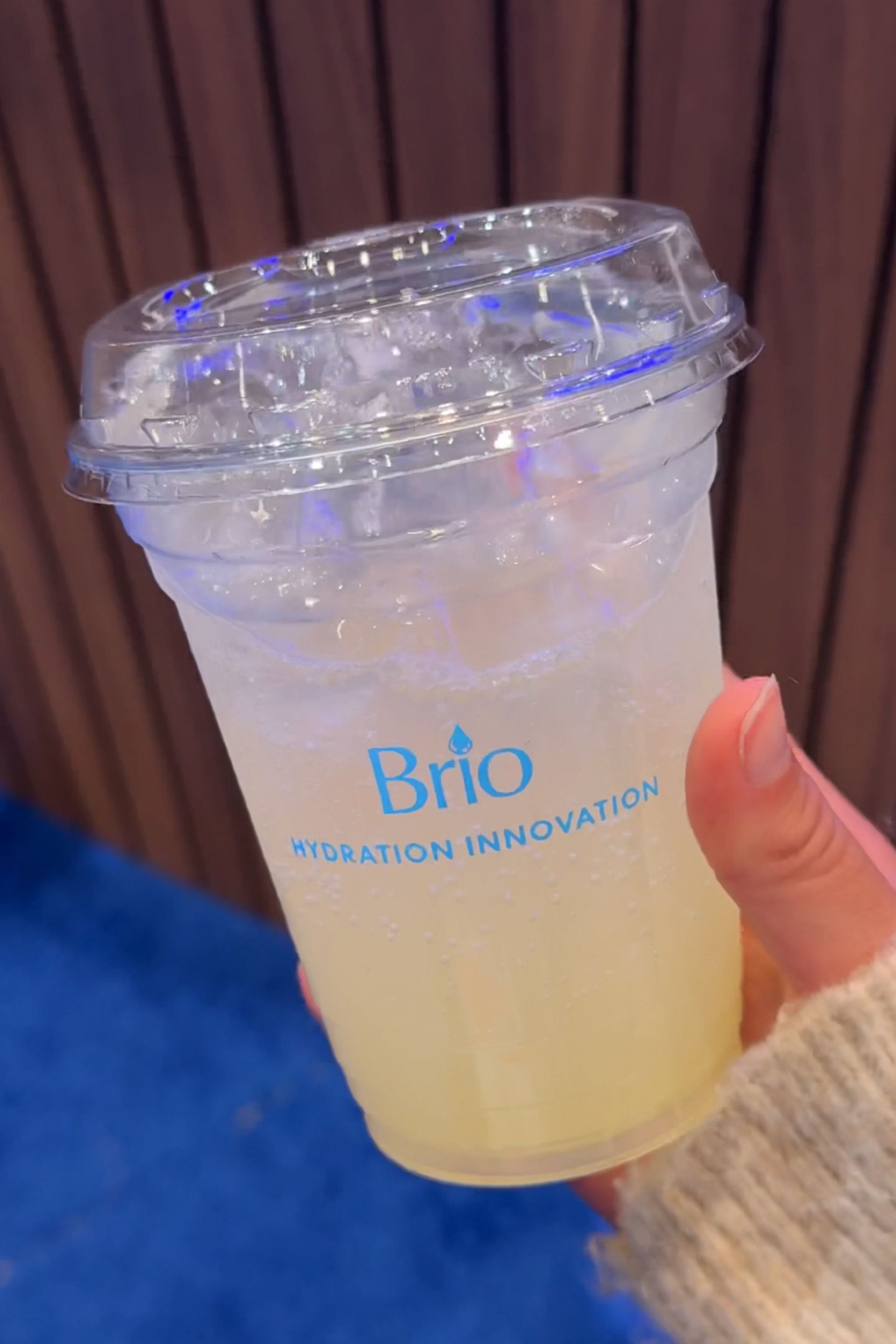 Holding a drink made with Brio sparkling water.
