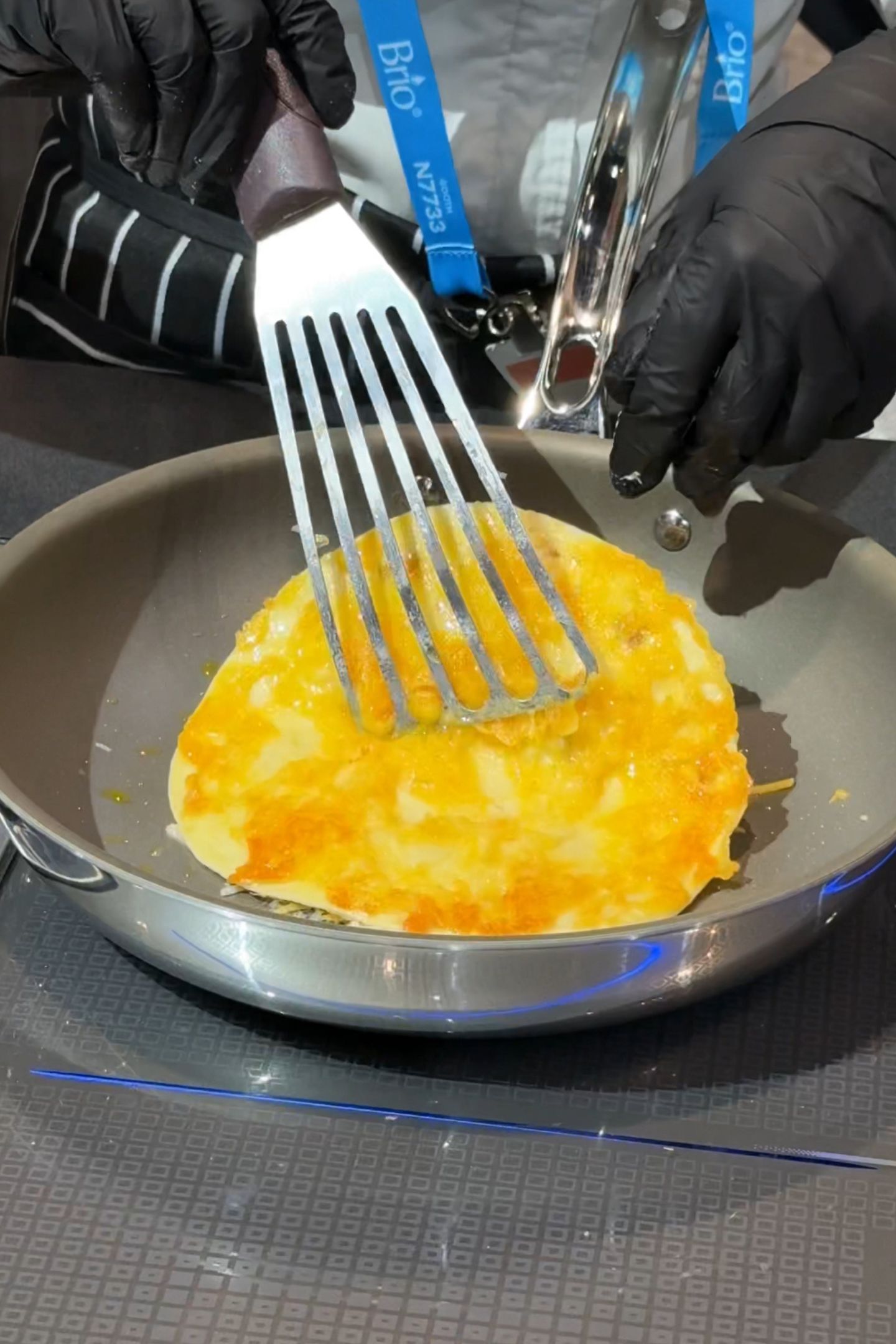 Flipping a cheese tortilla on a viking non-stick pan.