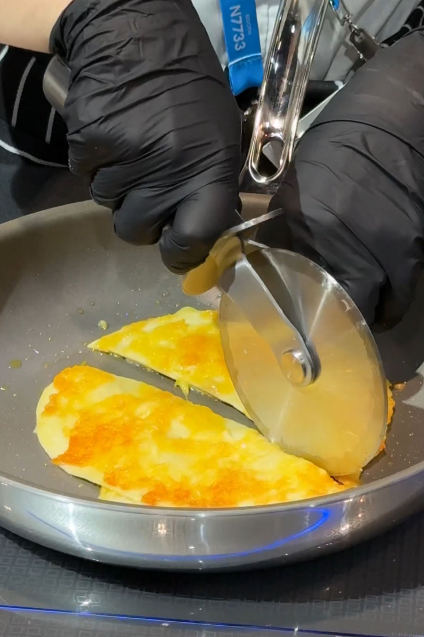 Cutting a cheese tortilla on a viking non-stick pan.