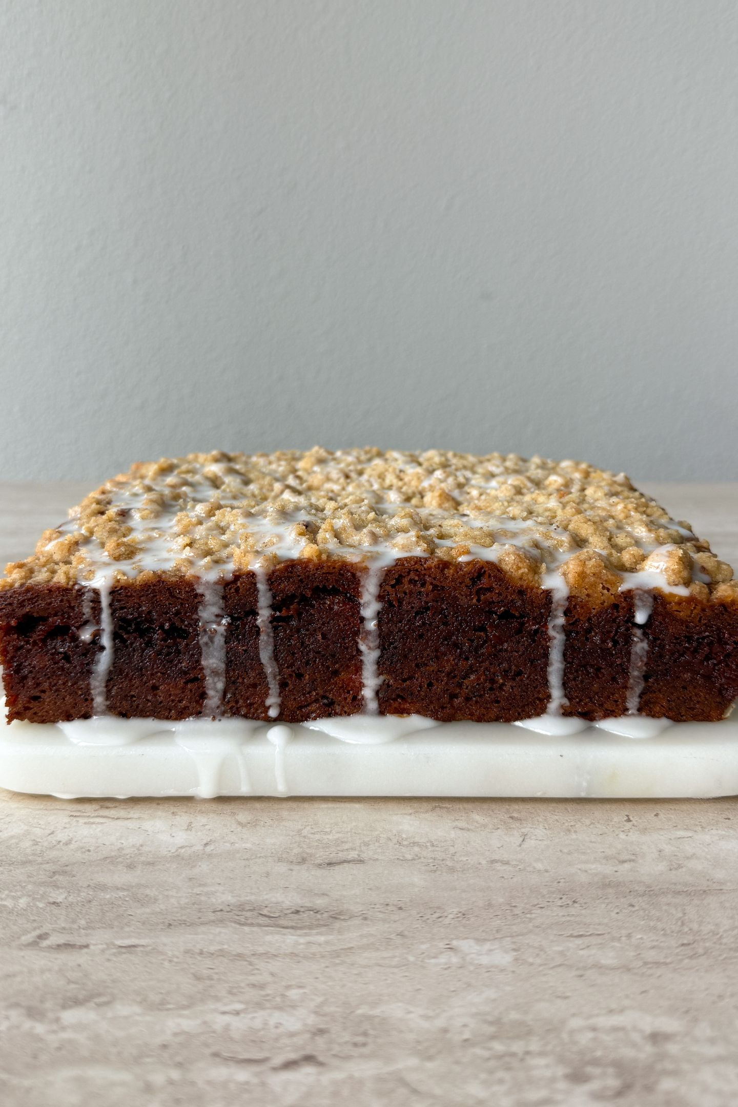 Side view of banana coffee cake topped with vanilla glaze.