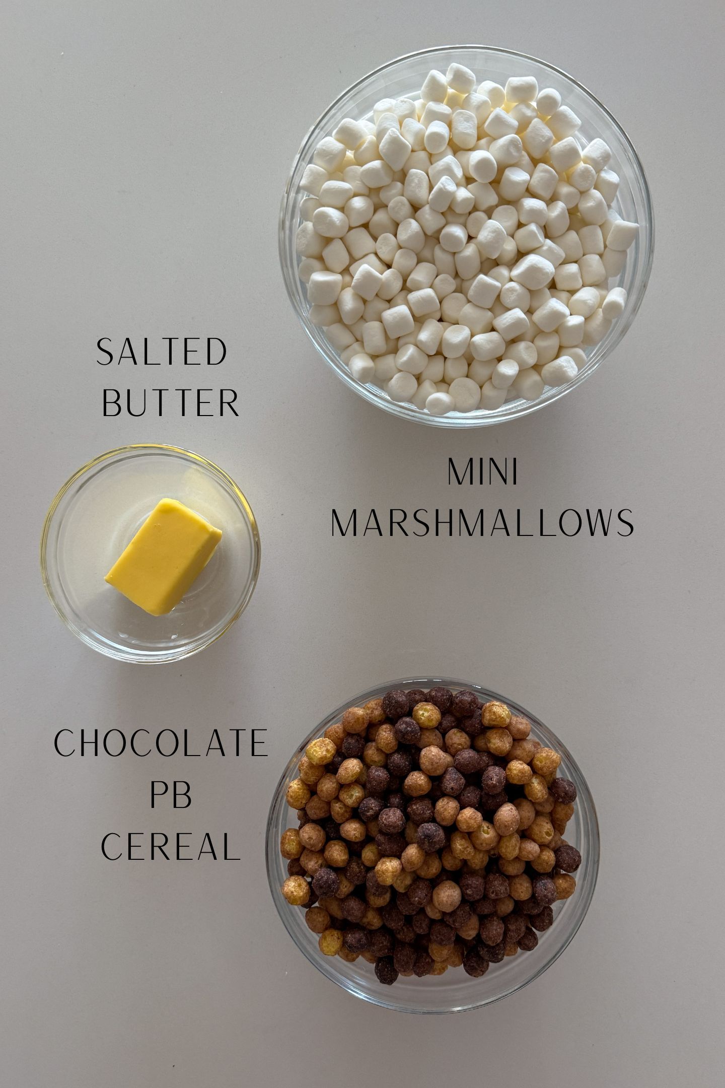 Ingredients to make the chocolate pb Rice Krispie treats in bowls.