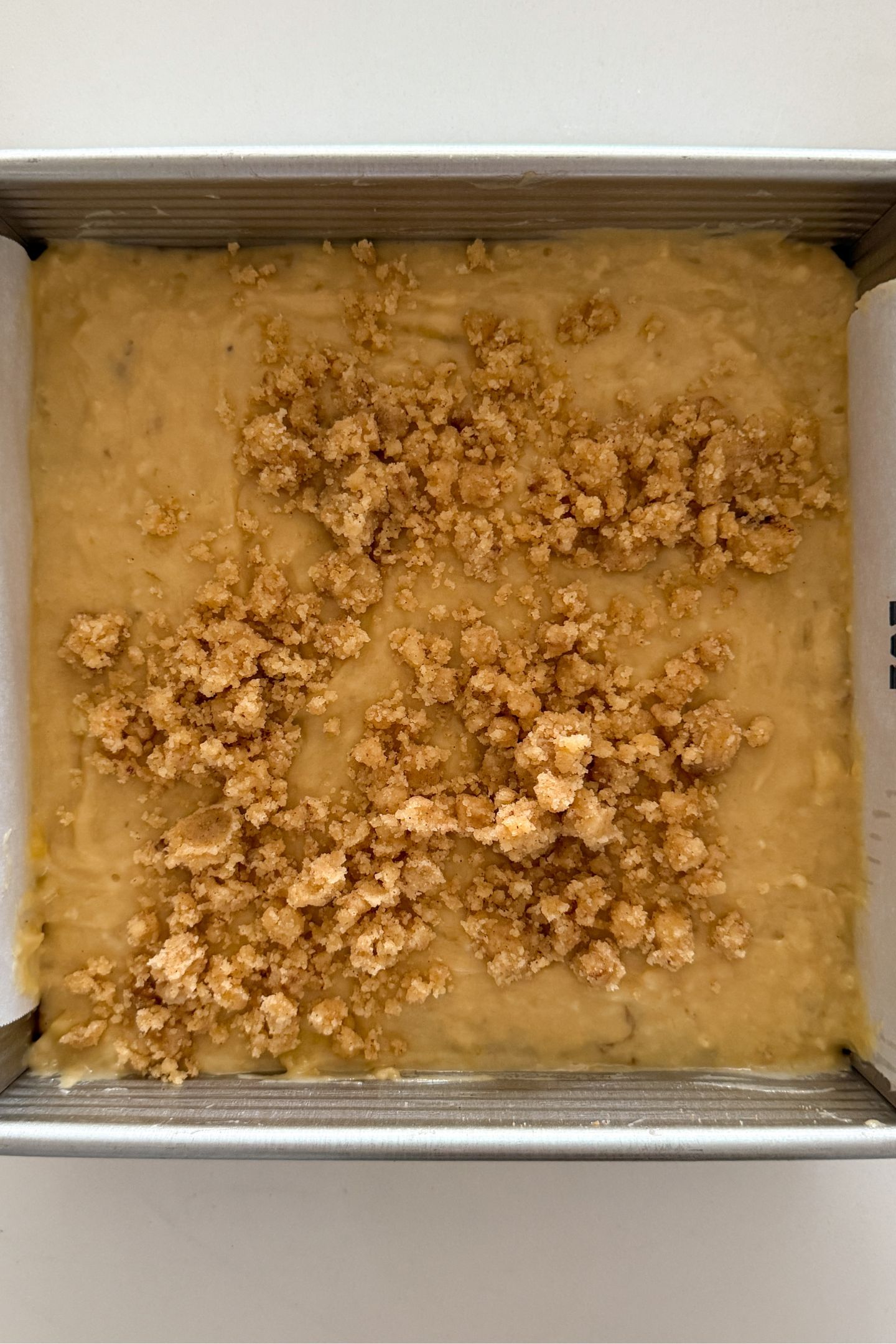 Adding the crumble on top of the butter.